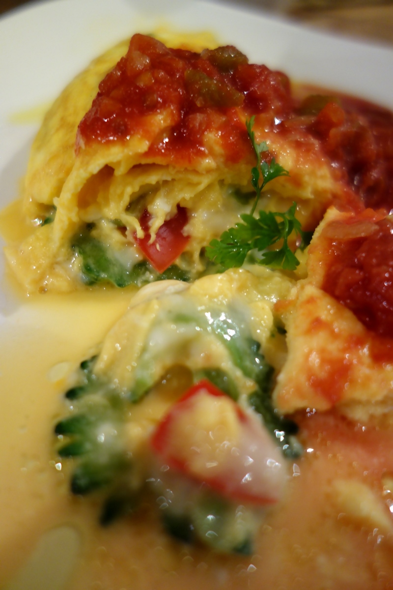 Omelette containing goya from Okinawa and cheese, topped with a spicy tomato sauce at なごかふぇ (Nago café, Tokyo, Japan) on 07 March 2014.